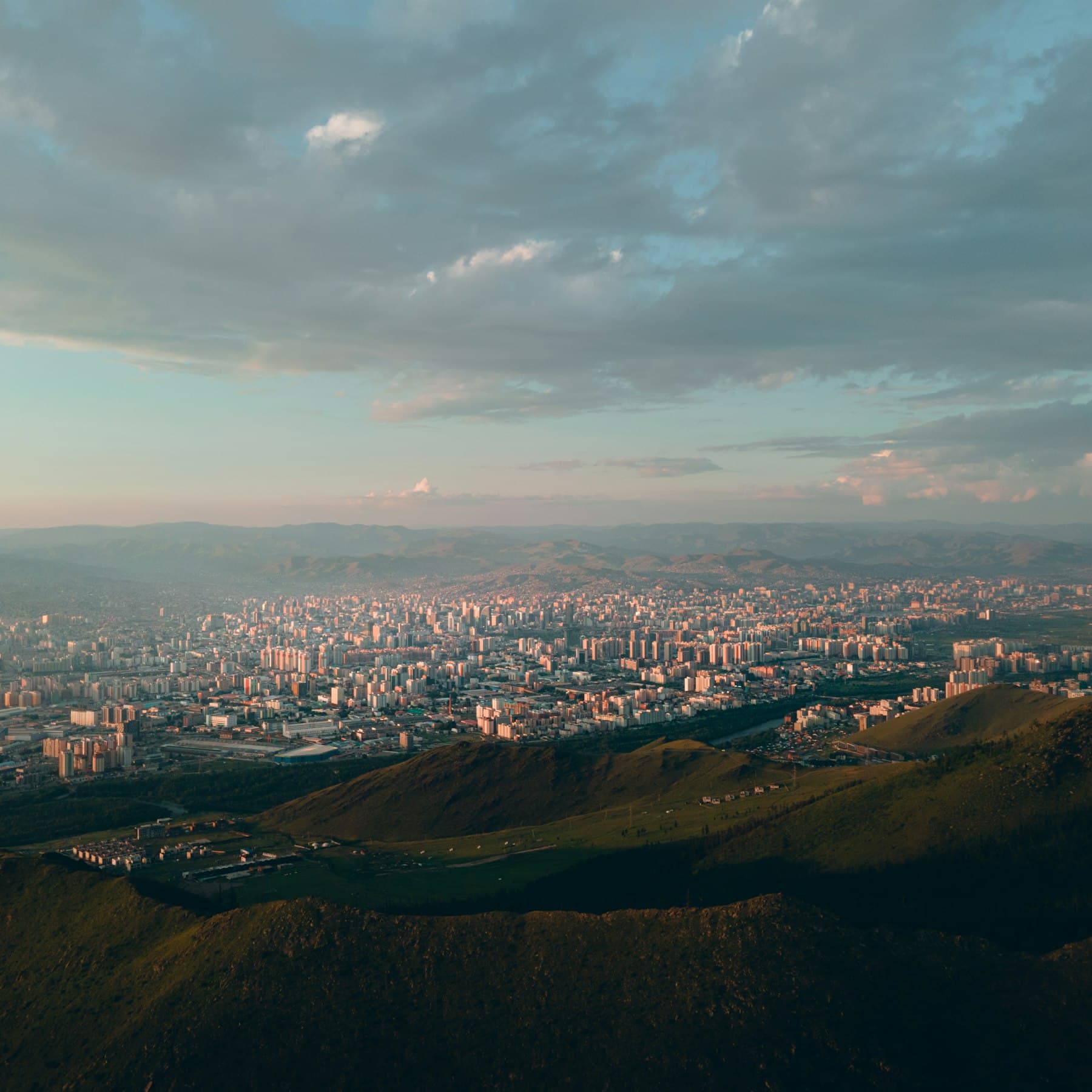 Ulaanbaatar spread out below the surrounding mountains at dusk